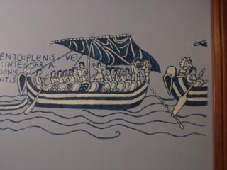 painting of a lot of guys in boats, heading out to die in battle
